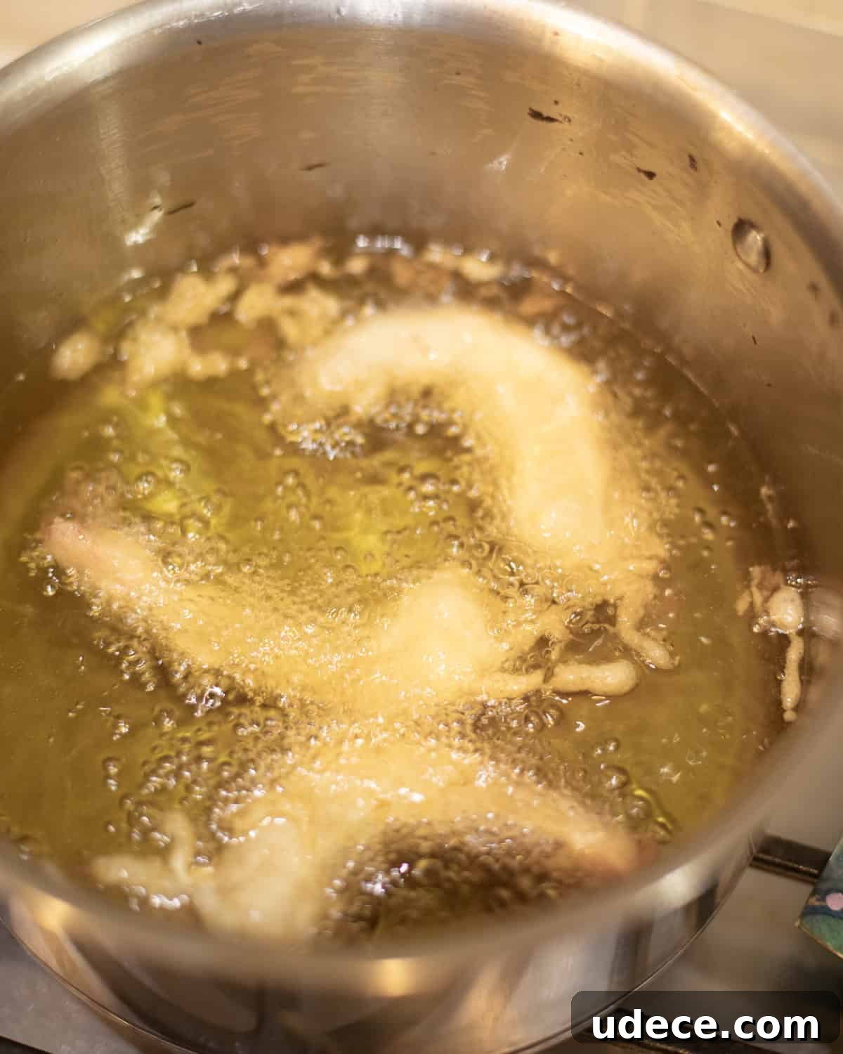 shrimp frying in oil in a pan. 
