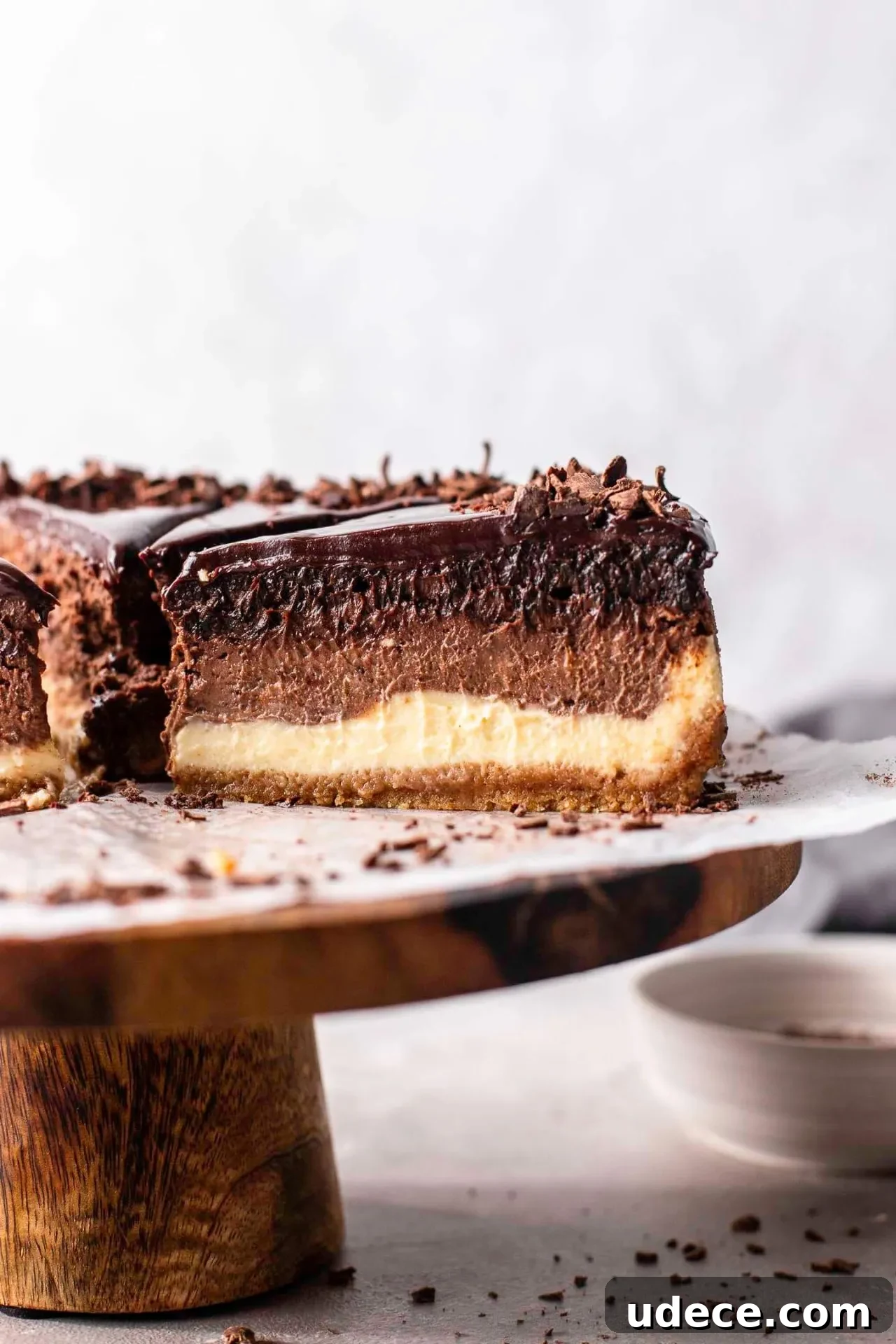 Decadent Chocolate Ombré Cheesecake Recipe 6 sliced ombre cheesecake on wooden cake stand (5)