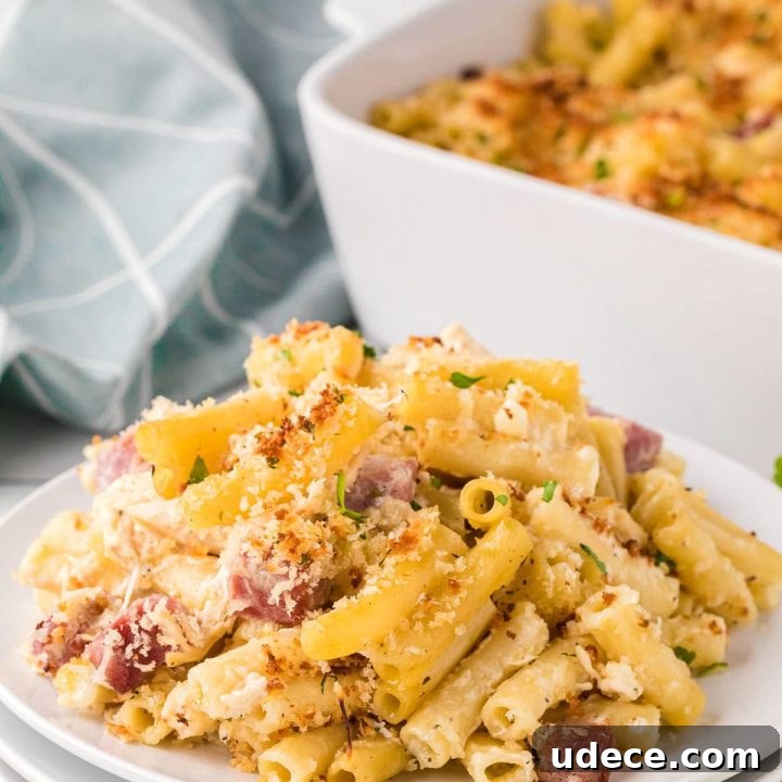 Cordon Bleu Casserole on a plate with a white baking dish in the background