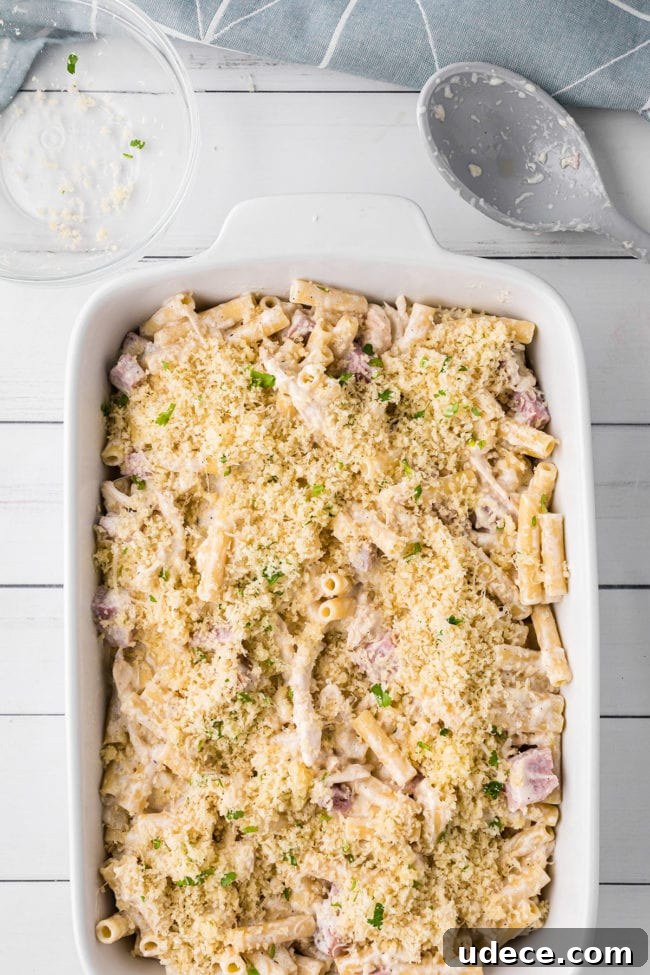 Creamy Chicken Cordon Bleu Pasta Bake 6 unbaked casserole in a white baking dish