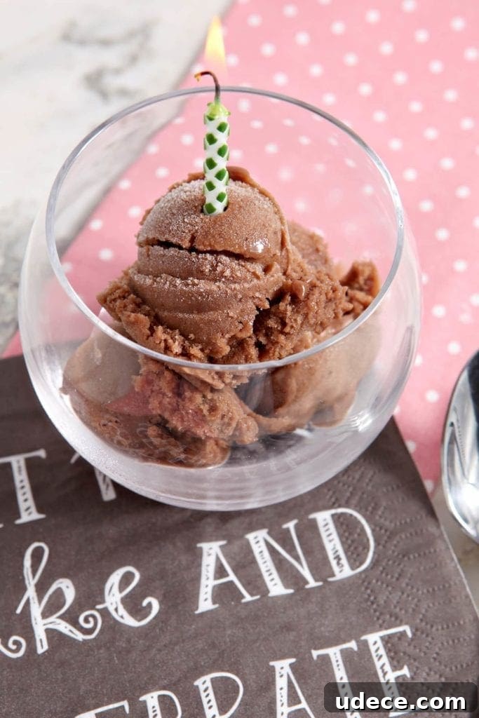 Decadent Chocolate Banana Ice Cream Recipe — Dairy-Free Treat 5 Overhead angled view of chocolate banana ice cream in glass with lit candle