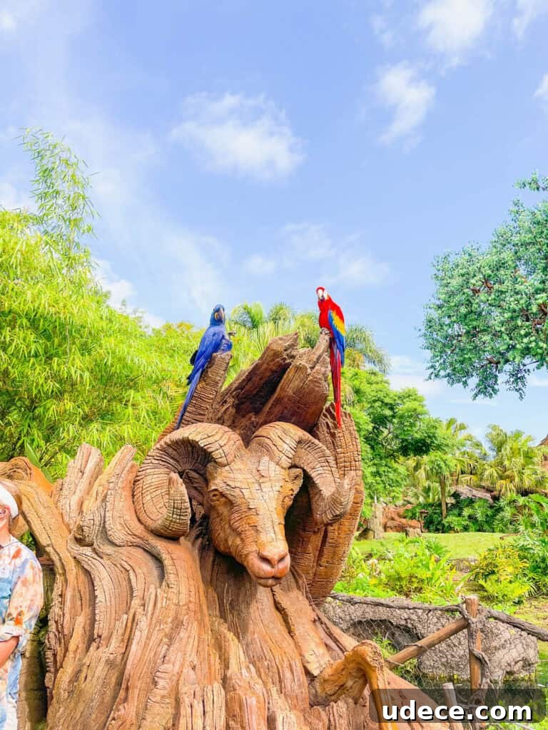 Discovering the Tree of Life at Disney's Animal Kingdom 7 Parrot and Macaw on top of a ram's head sculpture outside of the Tree of Life.