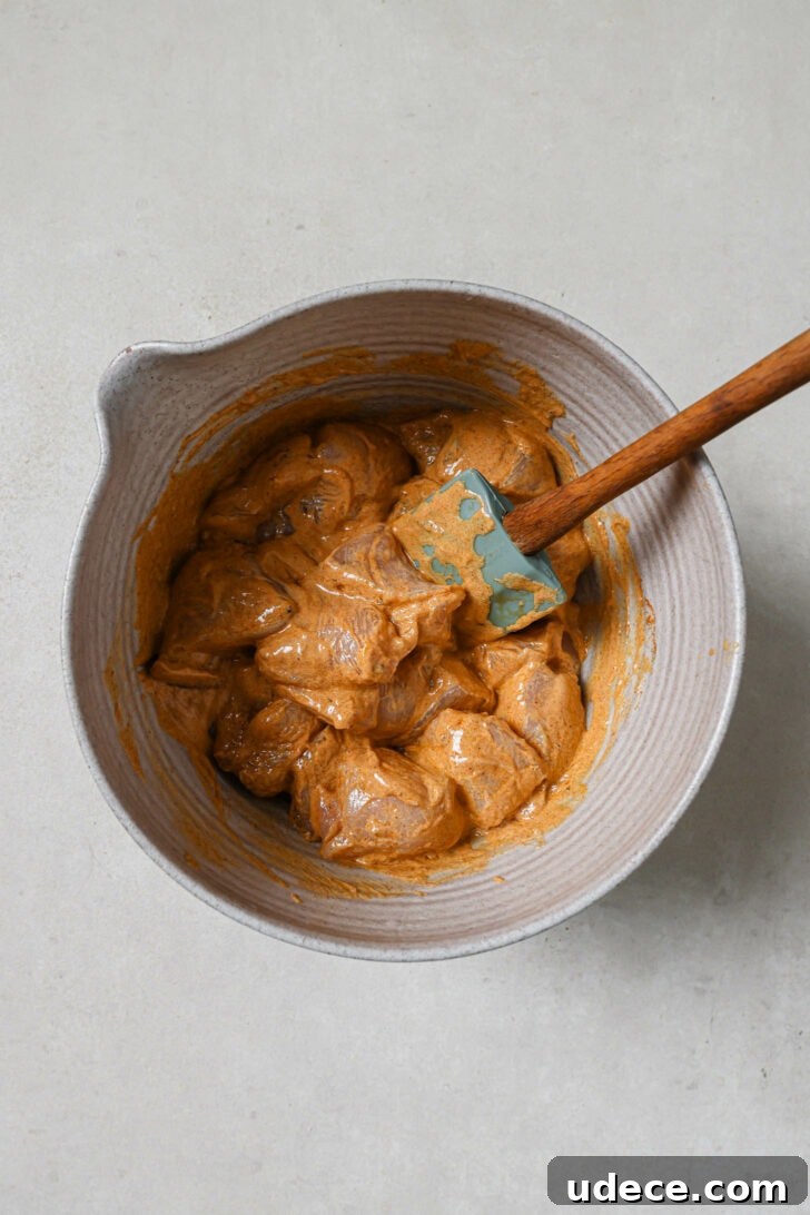 Authentic Butter Chicken Recipe: Tried and Perfected After 20 Tests 11 Chicken marinating in a grey bowl to make Butter Chicken.