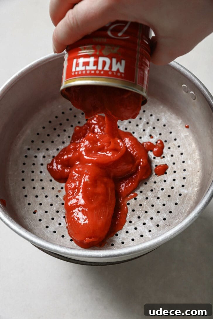 Authentic Butter Chicken Recipe: Tried and Perfected After 20 Tests 12 Draining liquid from a can of tomatoes.