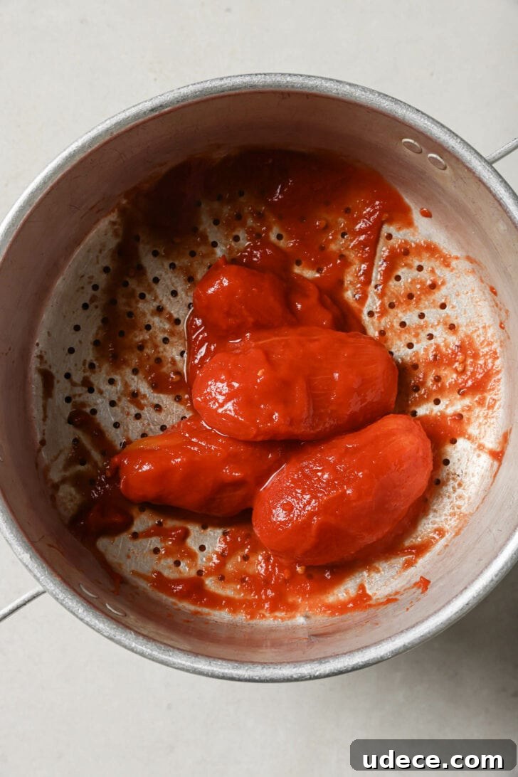 Authentic Butter Chicken Recipe: Tried and Perfected After 20 Tests 13 Drained canned whole tomatoes in a strainer.