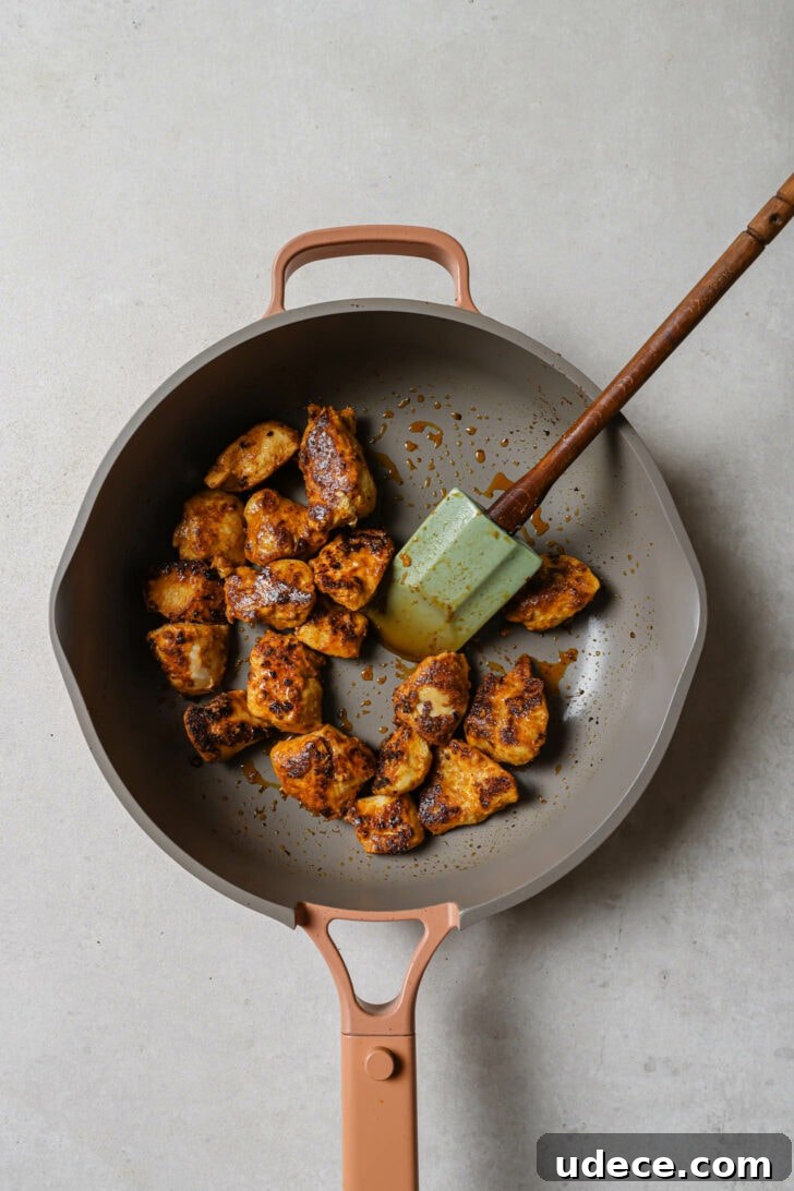 Authentic Butter Chicken Recipe: Tried and Perfected After 20 Tests 17 Cooked chicken in a skillet with a rubber spatula for Butter Chicken.
