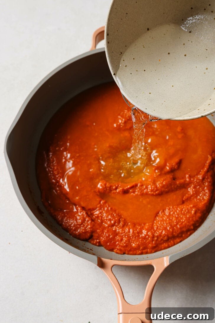Authentic Butter Chicken Recipe: Tried and Perfected After 20 Tests 27 Pouring water to skillet with tomato/onion mixture.
