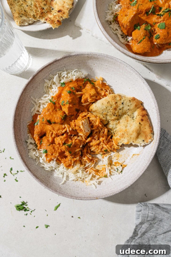Authentic Butter Chicken Recipe: Tried and Perfected After 20 Tests 37 Partially eaten bowl of Butter Chicken with rice and naan on the side.