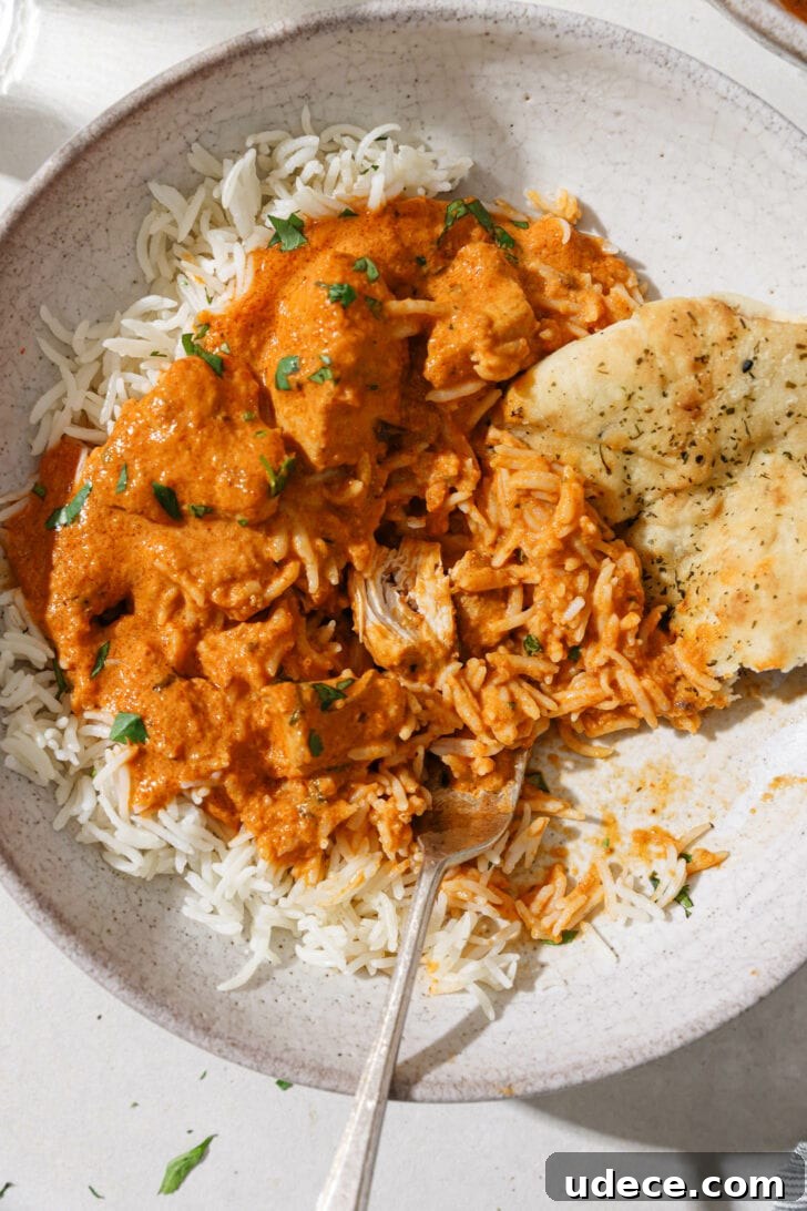 Authentic Butter Chicken Recipe: Tried and Perfected After 20 Tests 38 Partially eaten bowl of Butter Chicken with rice and naan on the side.