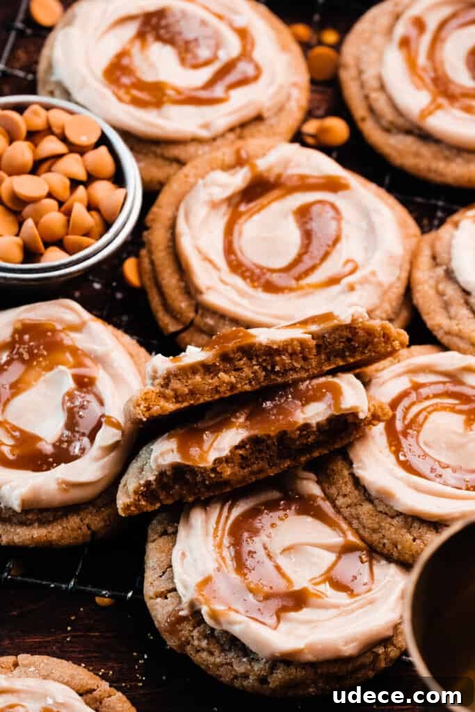 A butterbeer cookie broken in half, showing the chewy insides, nestled on a tray with the other cookies.