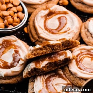 A close-up on a cookie broken in half, showing the chewy insides, nestled among the other butterbeer cookies.