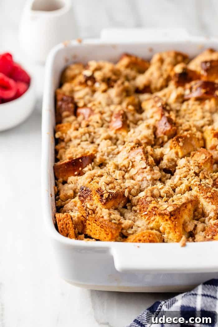 Overnight French Toast Casserole Recipe for Make-Ahead Brunch 11 Close up view of freshly baked overnight french toast casserole in a white baking dish set on a marble countertop