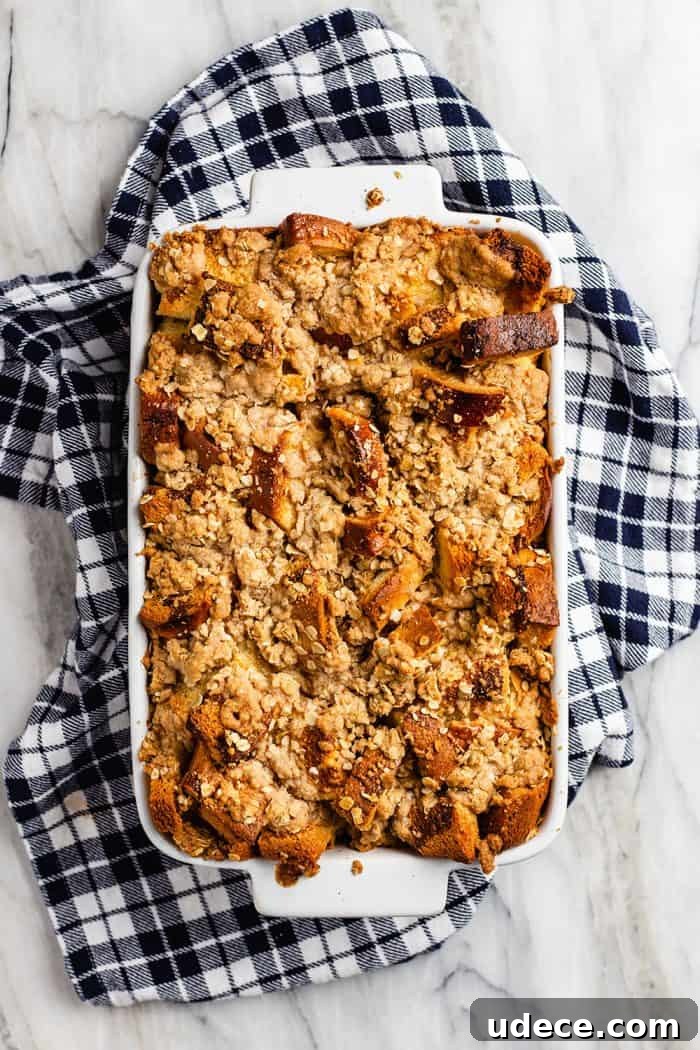 Overnight French Toast Casserole Recipe for Make-Ahead Brunch 7 Overhead view of freshly baked overnight french toast casserole in a white baking dish set on a blue plaid towel