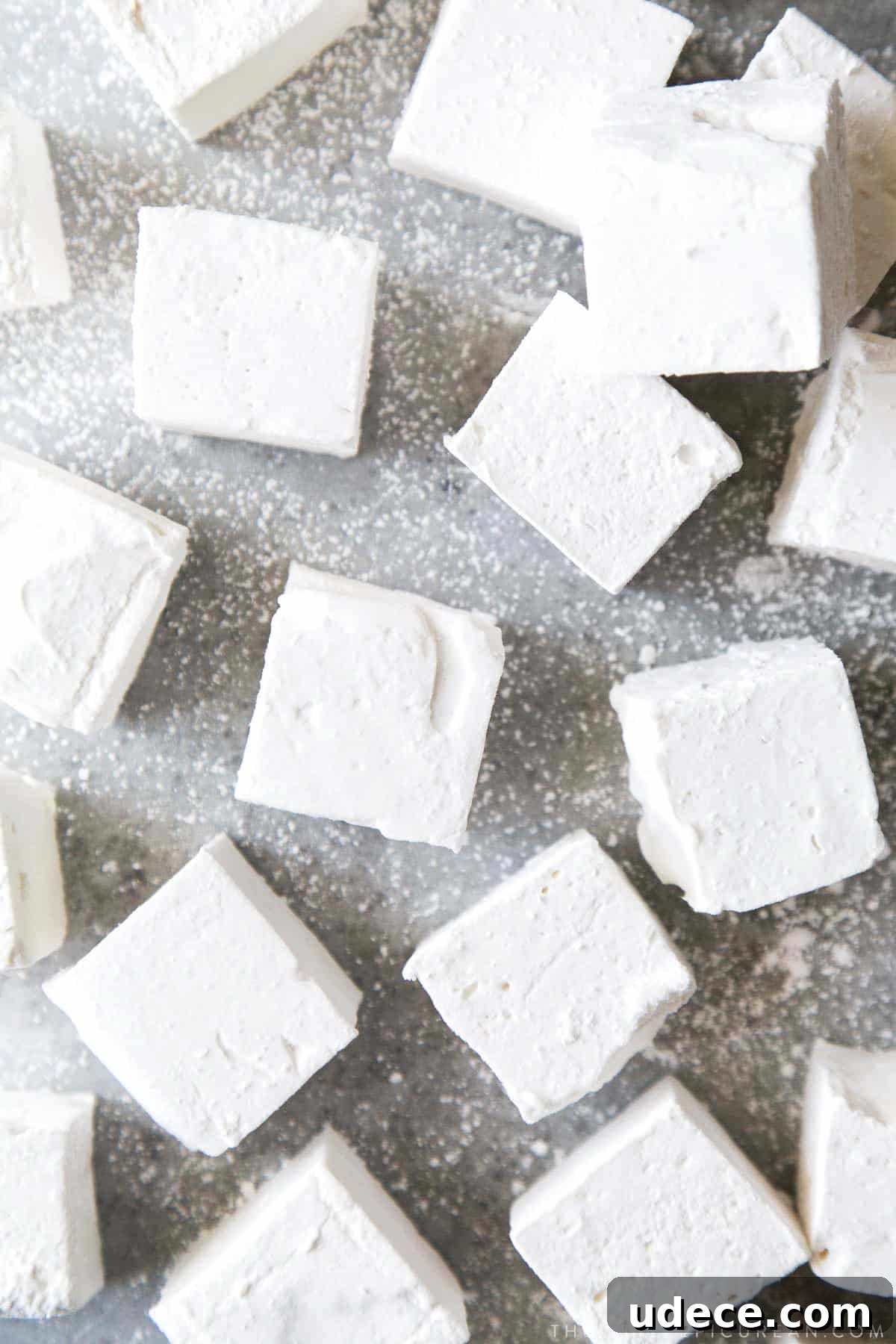 How to Make Fluffy Homemade Marshmallows at Home 2 fluffy marshmallow squares flavored with honey.