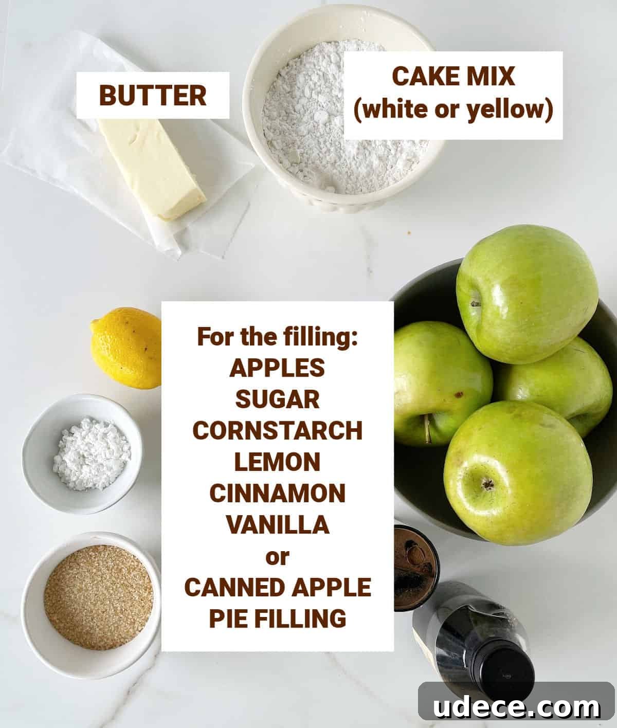 Caramel Apple Dump Cake Recipe — Quick Crowd-Pleasing Dessert 5 Ingredients for apple cake on white marble surface, including lemon, butter, spices, sugar, brown text overlay.