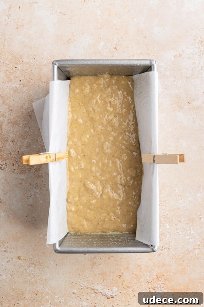 First layer of banana bread batter added to pan.