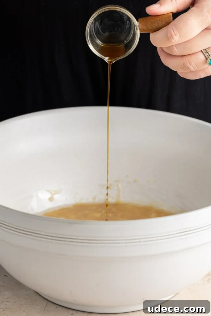 Adding vanilla extract to banana bread batter.