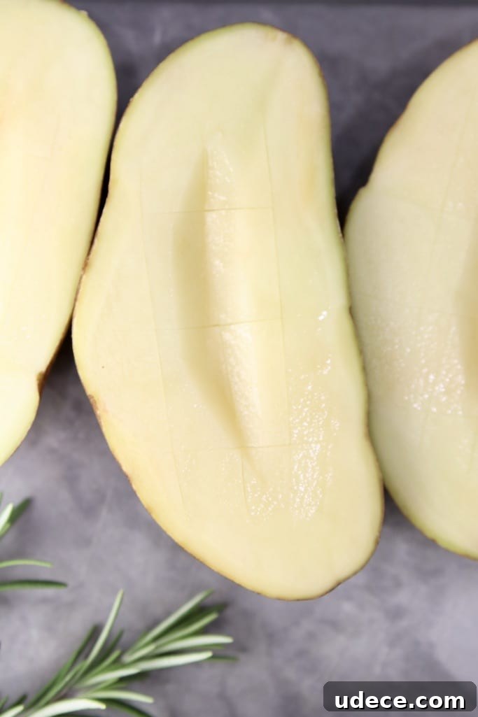 How to grill baked potatoes Russet potatoes cut in half with a wedge cut from center