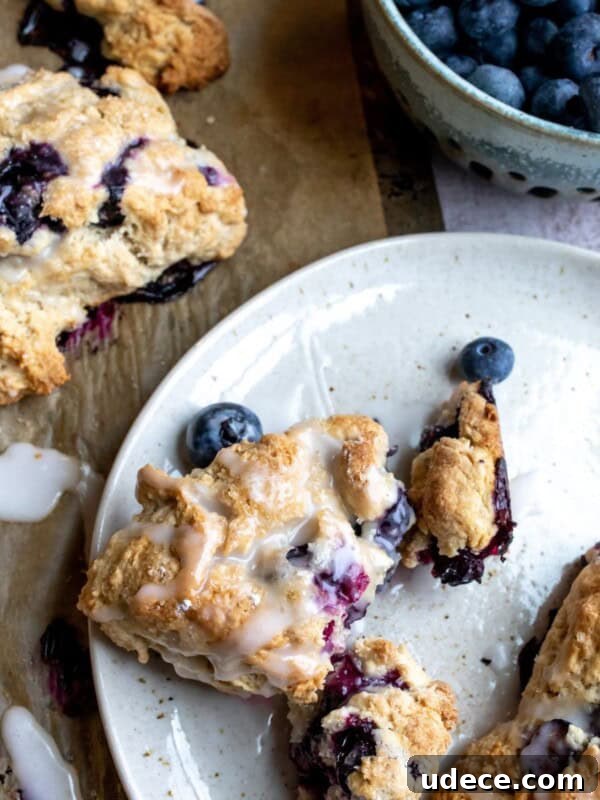 Homemade Blueberry Syrup Recipe for Pancakes and Desserts 7 Blueberry Cardamom Scones on a white plate.