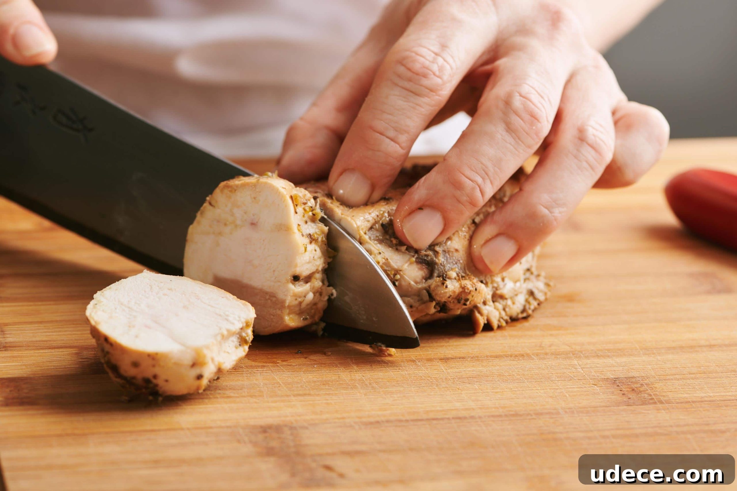 How to Cube Chicken Breast for Evenly Cut Pieces 3 Woman slicing cooked chicken breast.