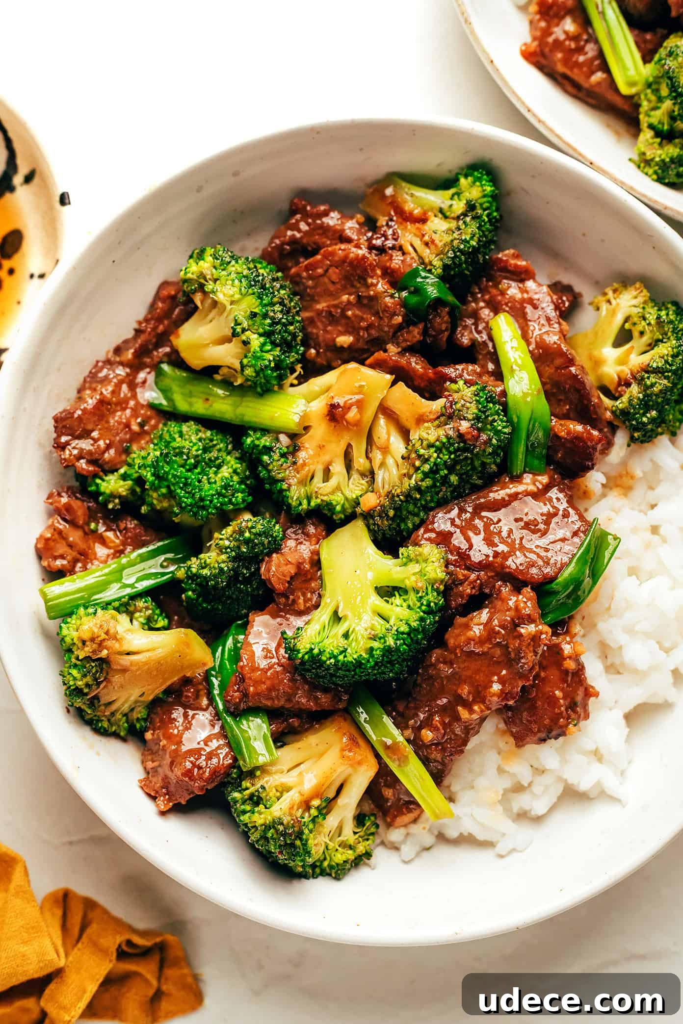 This easy beef and broccoli stir-fry features tender steak, crisp broccoli, and a bold, garlicky sauce — all ready in just 30 minutes. beef and broccoli served over rice in bowl