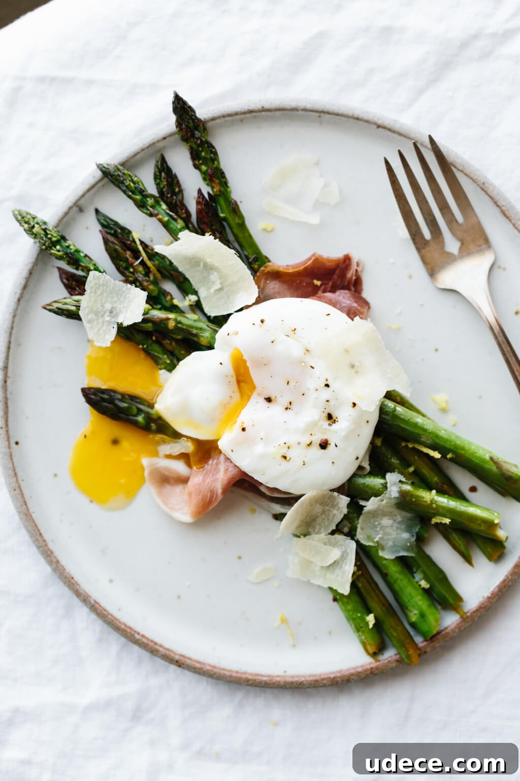 Breakfast doesn't get much better than garlic sautéed asparagus topped with prosciutto, a perfectly poached egg and a few shavings of parmesan.