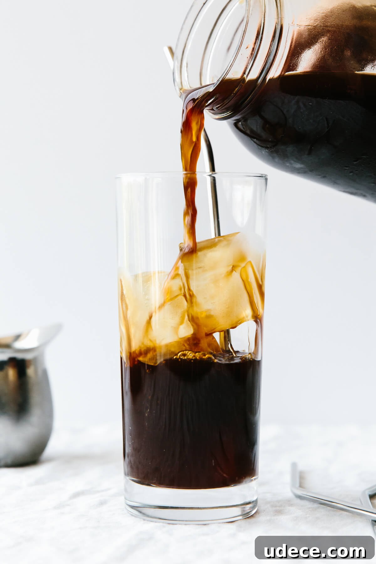 Pouring cold brew into a cup of ice