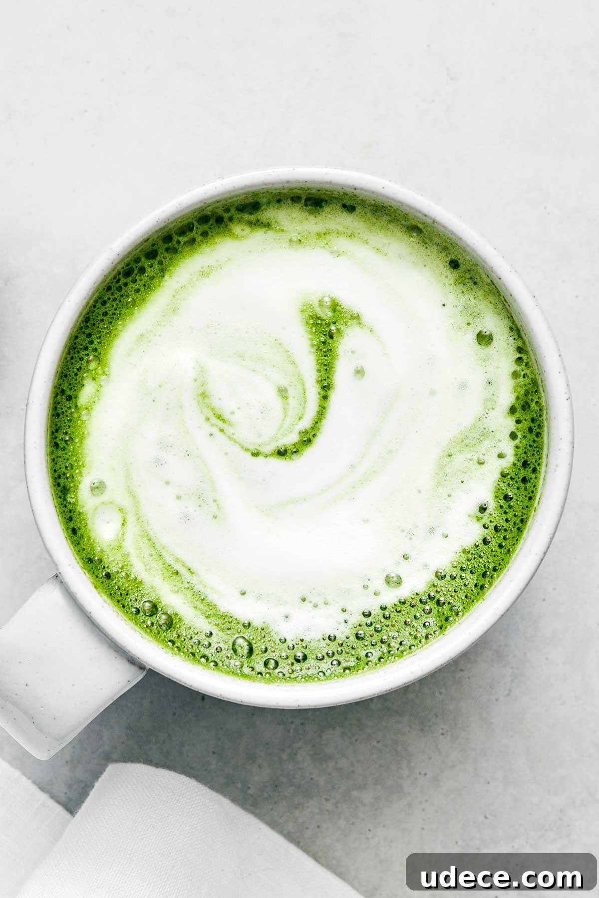 A white mug of matcha latte.