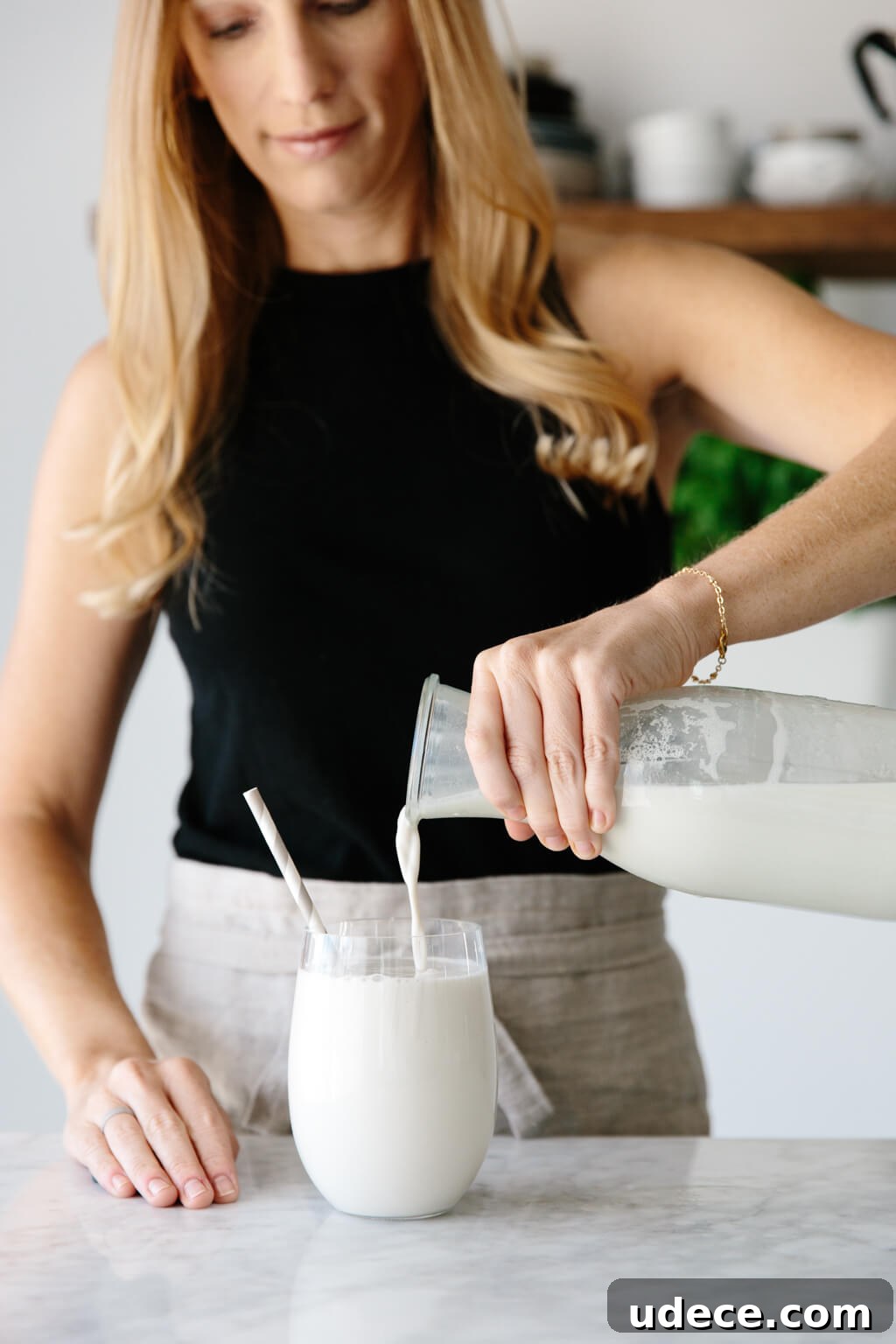 Cashew milk being poured into a glass