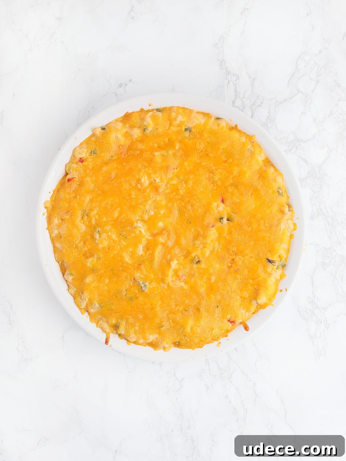 corn dip topped with melted cheese after it has been baked in the oven
