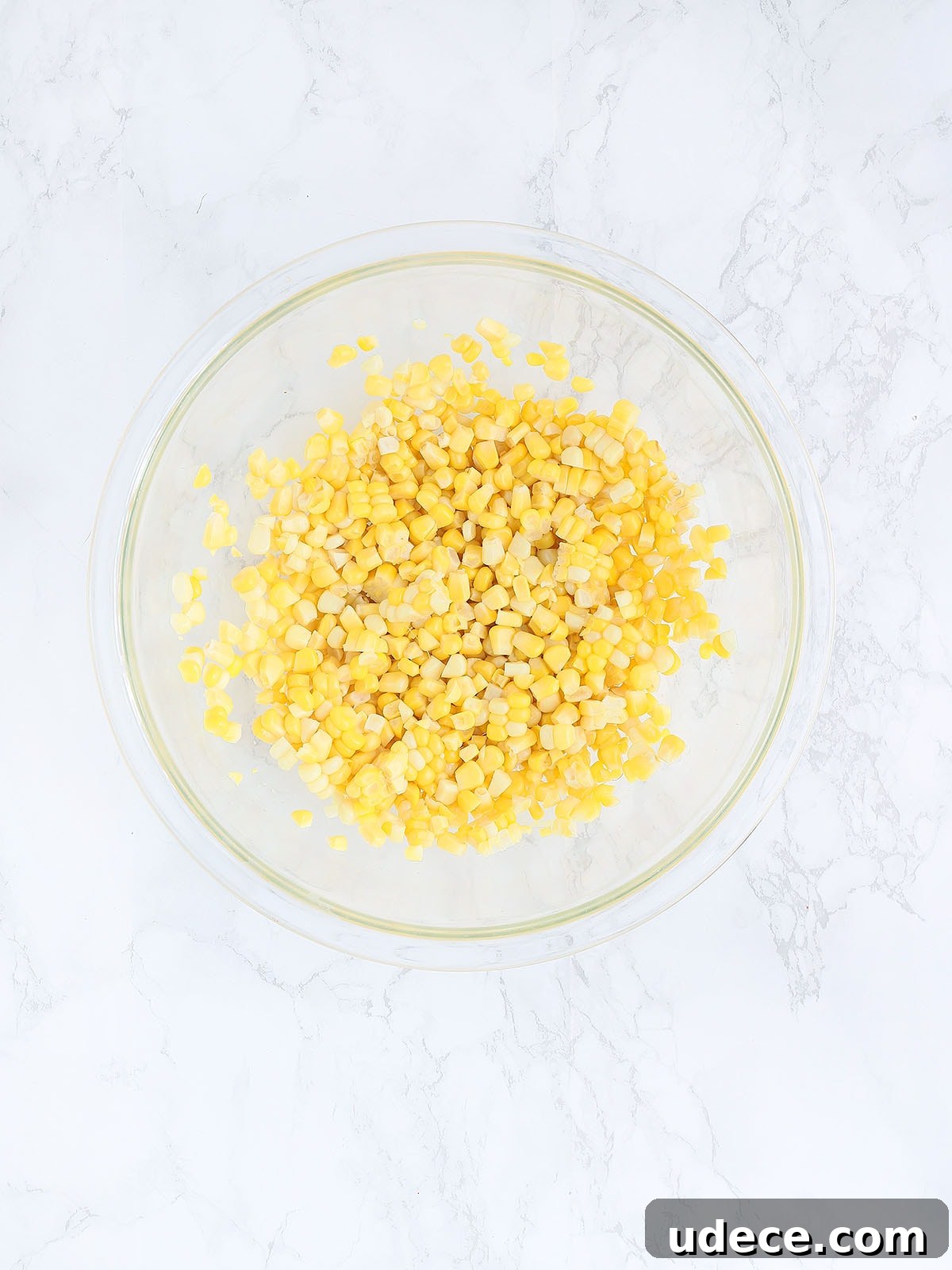 corn kernels in a large glass mixing bowl