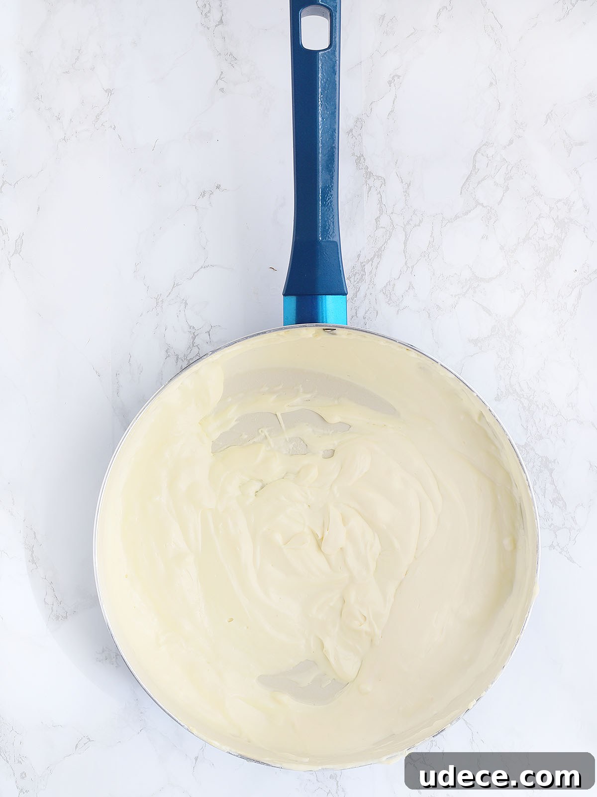cream cheese, mayonnaise and sour cream melted in a large blue skillet