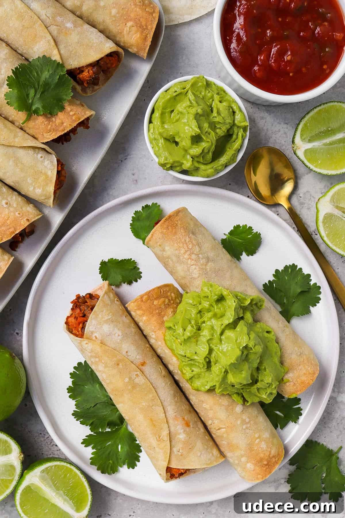 Vegan Lentil and Roasted Cauliflower Taquitos Recipe 3 Taquitos served on plate on the side topped with guacamole.