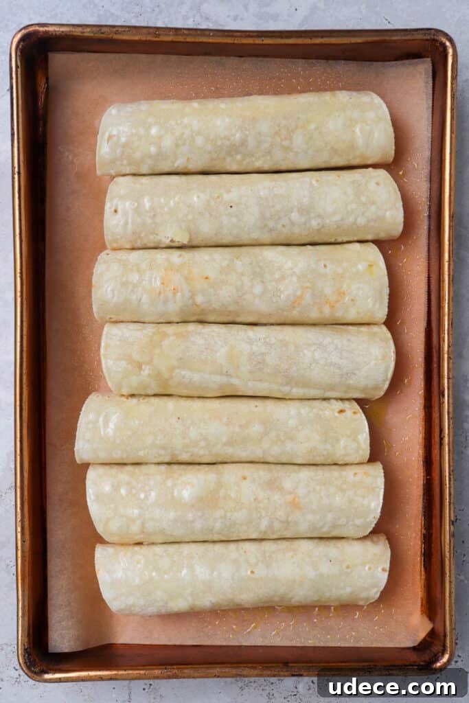 Vegan Lentil and Roasted Cauliflower Taquitos Recipe 6 Taquitos on baking tray before being baked.
