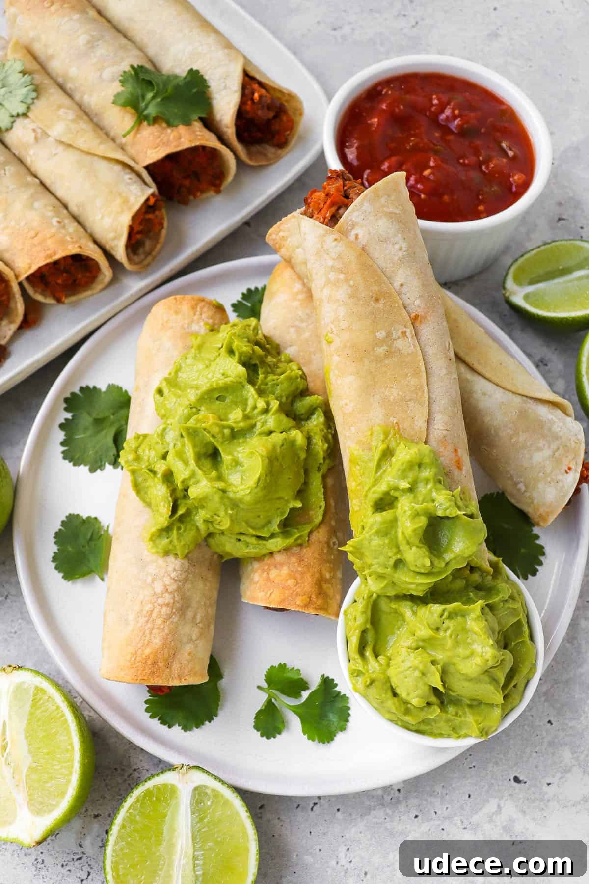 Vegan Lentil and Roasted Cauliflower Taquitos Recipe 8 Taquitos on a plate dipped in the guacamole.