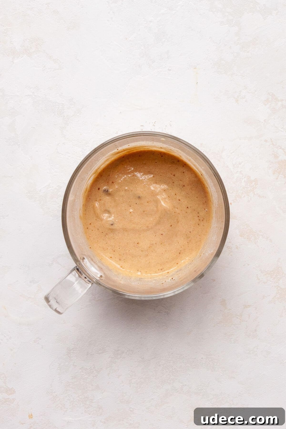 Protein Powder Mug Cake Recipe — Quick Single-Serve Dessert 5 Protein mug cake batter in a glass mug before microwaving.