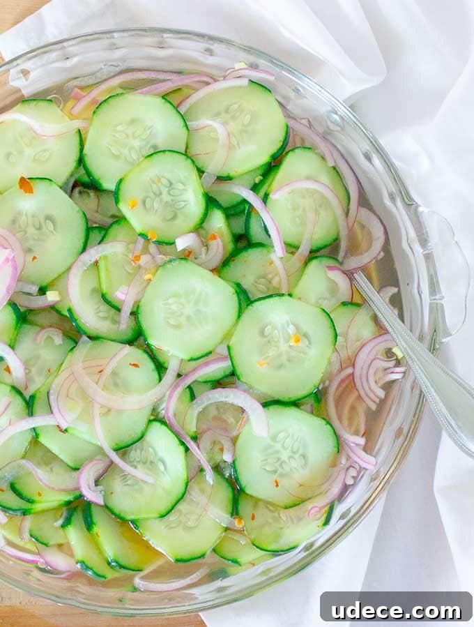 Tangy Pickled Cucumber & Red Onion Salad Recipe 2 Pickled Cucumber and Red Onion Salad in clear bowl on a white cloth