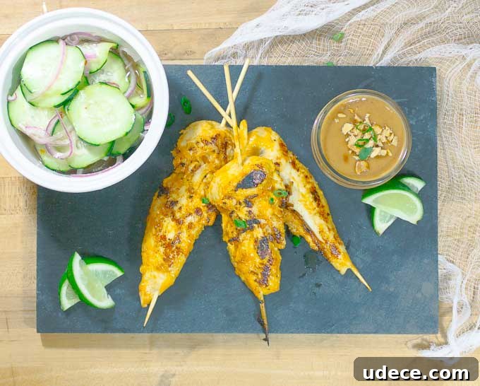 Tangy Pickled Cucumber & Red Onion Salad Recipe 3 Thai Chicken Satay Skewers on blackslate with cucumbers and peanut sauce