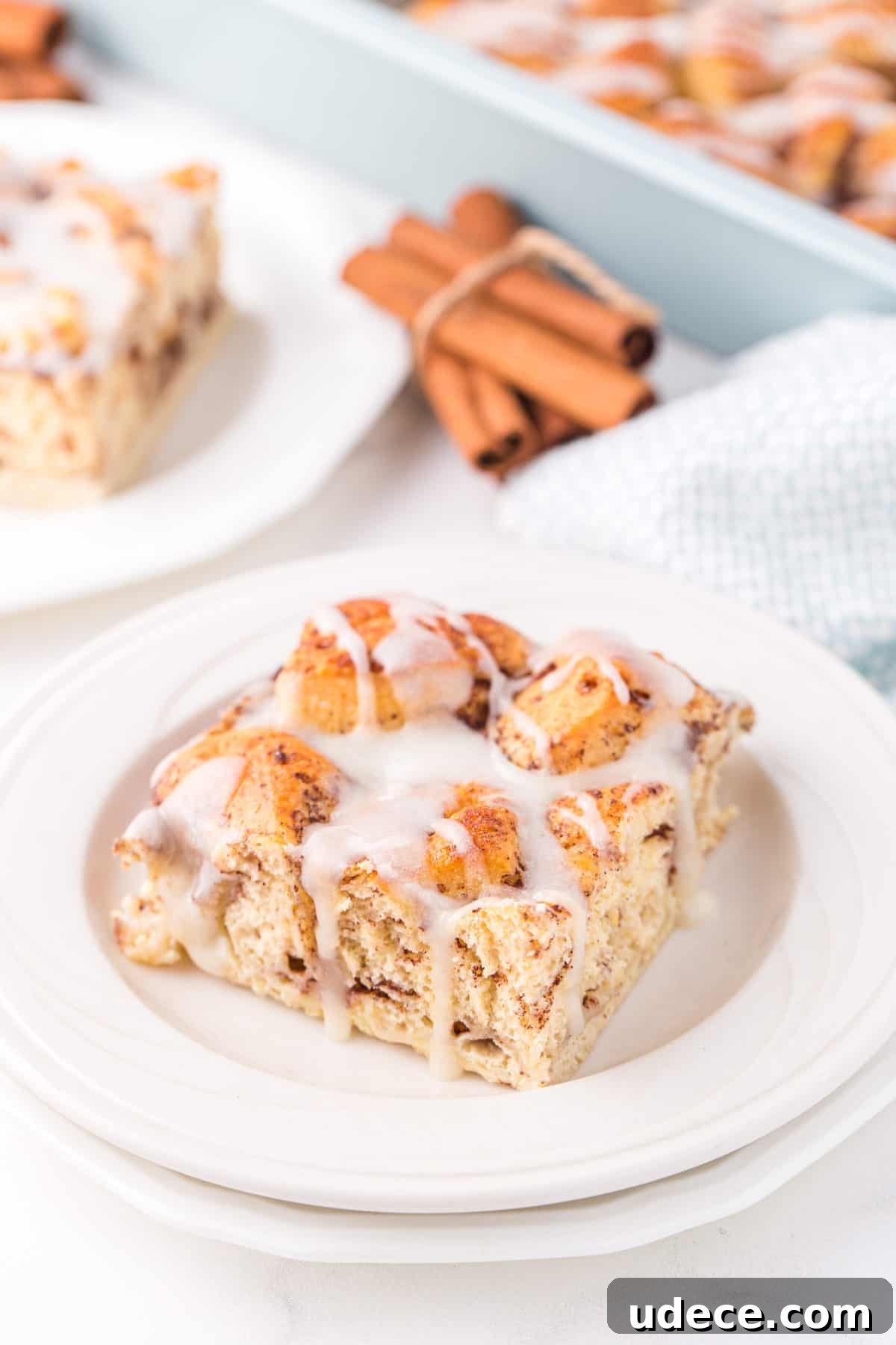 slice of breakfast casserole with icing on white plate