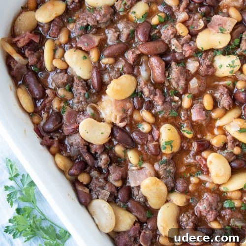 calico baked beans in a white casserole dish.