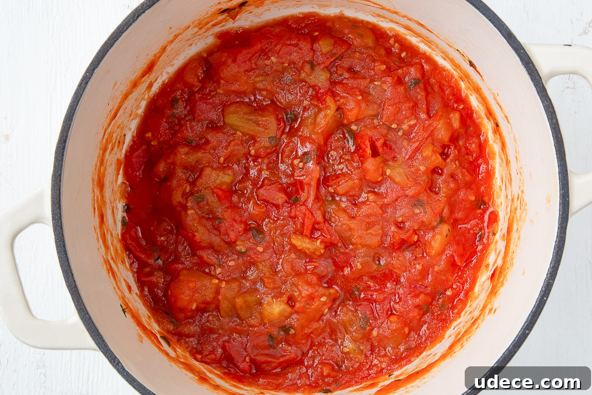 Homemade Tomato Jam Recipe: Sweet & Savory Preserving Guide 6 tomato jam in a large white dutch oven