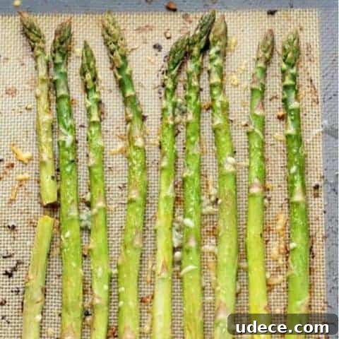 roasted asparagus spears on a baking tray