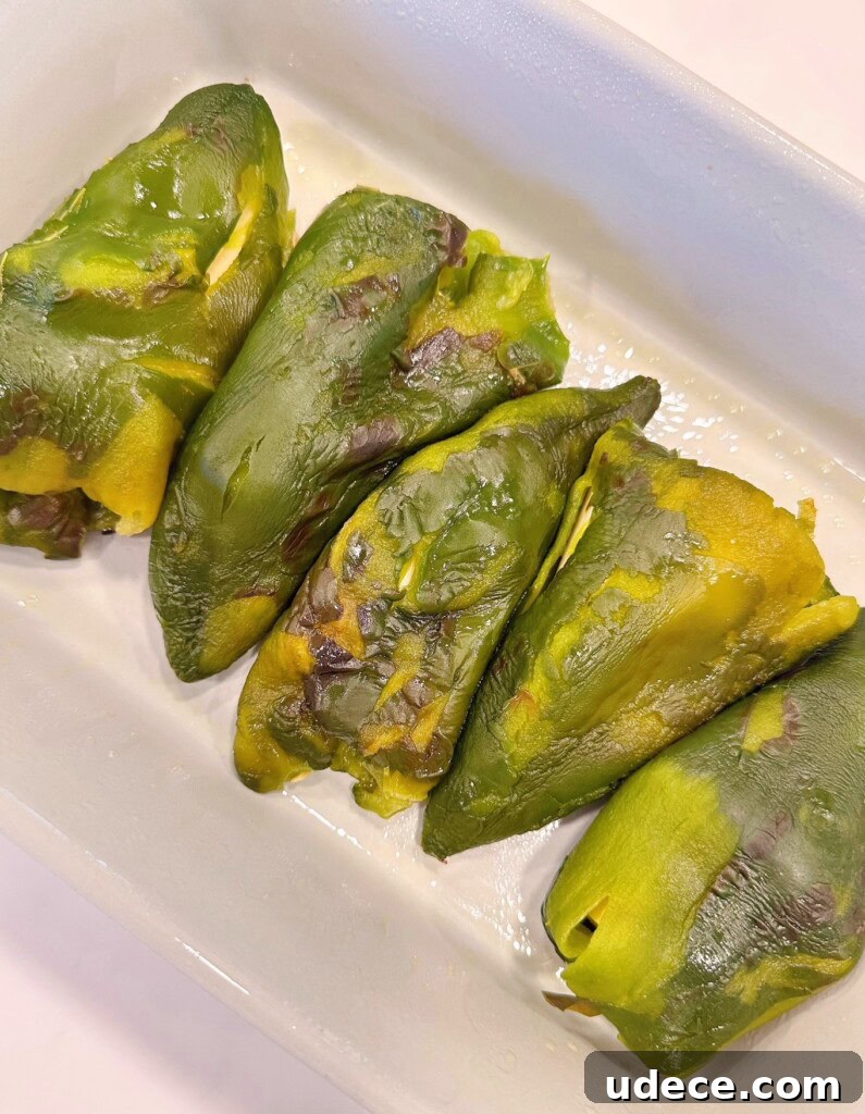 Chili Relleno Casserole Recipe: Cheesy Roasted Poblanos Bake 10 Stuffed chili peppers arranged in a casserole dish.