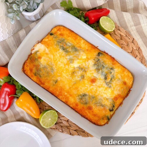 Chili Relleno Casserole Recipe: Cheesy Roasted Poblanos Bake 19 Chili Relleno Casserole in a grey casserole dish surround by peppers and limes.