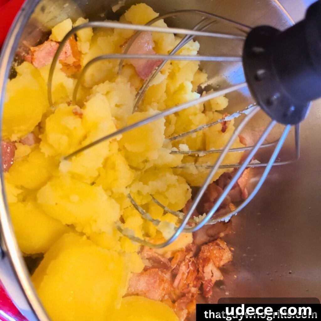 Smoked Cheesy Loaded Potatoes Recipe for Camping or BBQ 3 Gold potatoes being mixed with ingredients for loaded potatoes