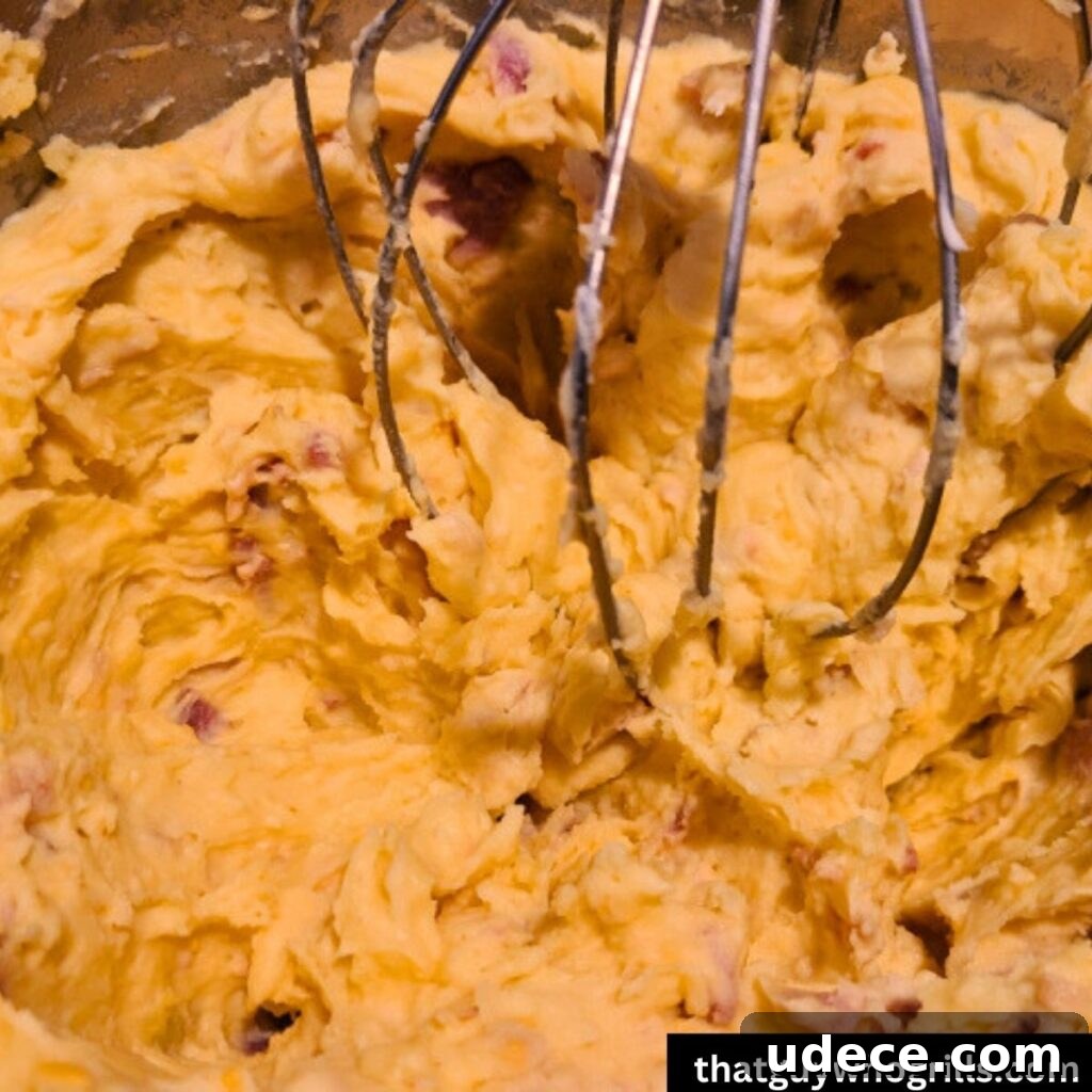 Smoked Cheesy Loaded Potatoes Recipe for Camping or BBQ 4 Loaded potatoes mashed in mixing bowl together