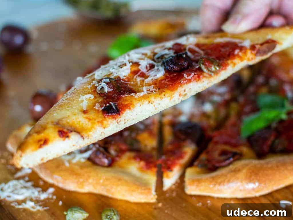 Calabrese Pizza: Spicy Italian Pepperoni & Calabrian Chili Recipe 6 close up of slice of calabrese pizza.