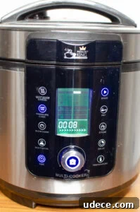 Authentic Pressure Cooker Chicken Biryani Recipe – Ready Fast 8 Picture of a pressure cooker King Pro with lid closed down and on pressure cook setting with 8 min timer
