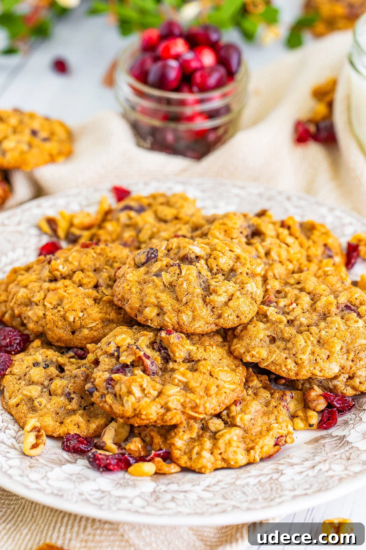 Chewy Cranberry Oatmeal Cookies with Walnuts — Soft, Tangy Bites 2 Cranberry Oatmeal Cookies on a tan serving plate
