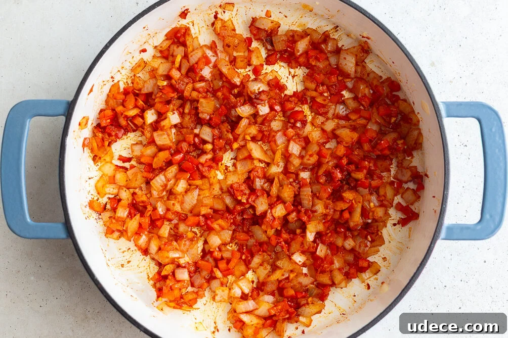 Vegan Lentil Sloppy Joes Recipe for Flavorful Plant-Based Sandwiches 7 how to make vegan sloppy joes: sauteed veggies in a pan with tomato paste mixed in